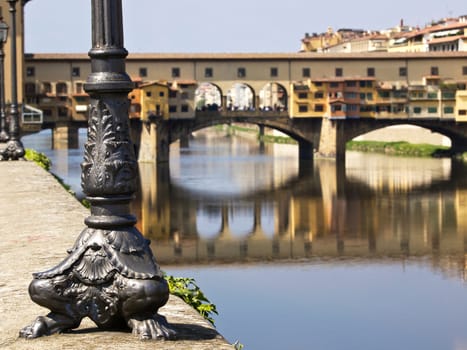 electric light post looking on the ponte vecchio bridge in Florence Italy