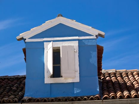 blue hose construction with white window on the roof