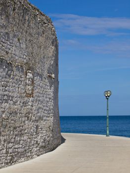 stone wall and sidewalk near the sea