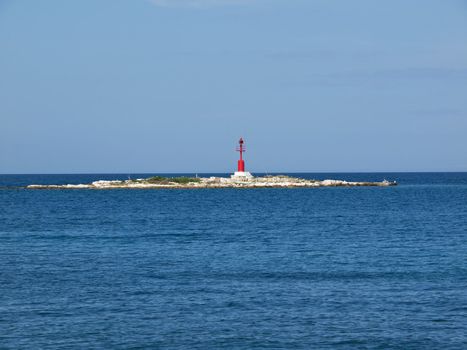 red lighthouse on a small island