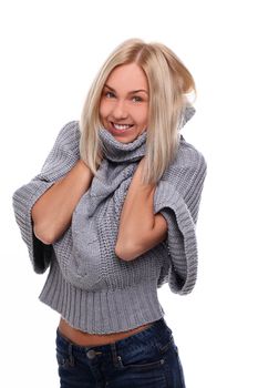 Charming blonde in sweater feeling cold over a white background
