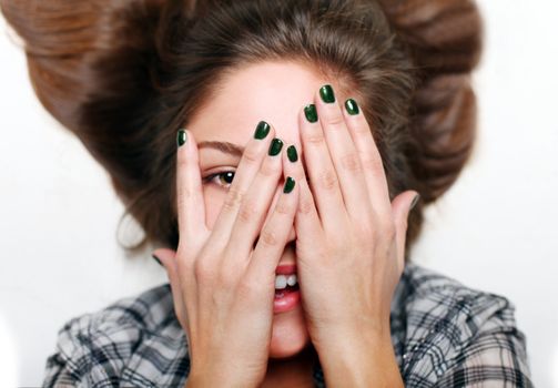 Close up of beautiful woman face with hands over lying on a floor