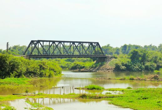 Ancient bridge over the river in Thailand