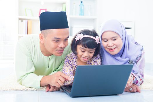 Southeast Asian family browsing internet at home. Muslim family living lifestyle