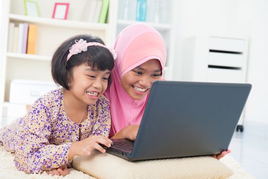 Southeast Asian females surfing internet at home. Malay Muslim girls.