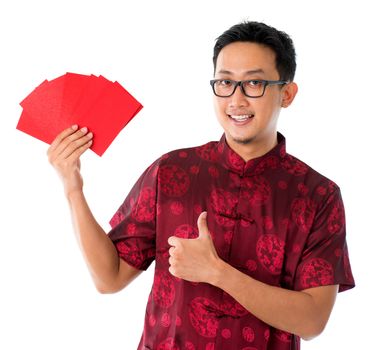 Thumb up Asian Chinese man showing many red packets / ang pow , isolated on white background