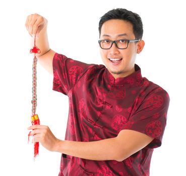 Southeast Asian Chinese man decorating for Chinese new year