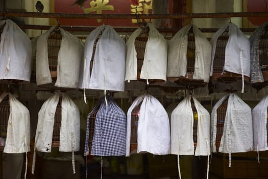 Covered bird cages in the Yuen Po Street Bird Garden in Kowloon, Hong Kong.