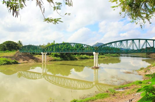 Ancient bridge over the river in Thailand