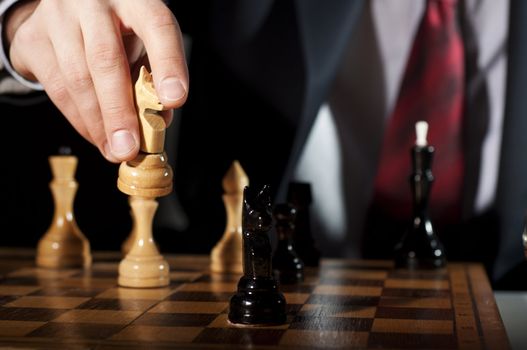 image of the businessman in a business suit plays chess