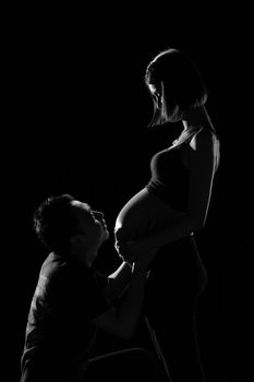 Asian couple looking at his wife, who was pregnant last week before the birth. With love and care.