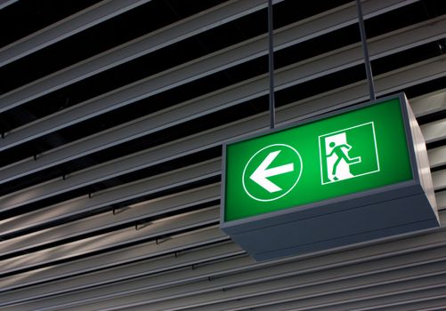 Emergency exit sign in modern offices inside an industrial plant