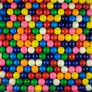 Multi-colored slightly irregular round bubblegum balls with vibrant rainbow colors in a hexagonal circle packing arrangement