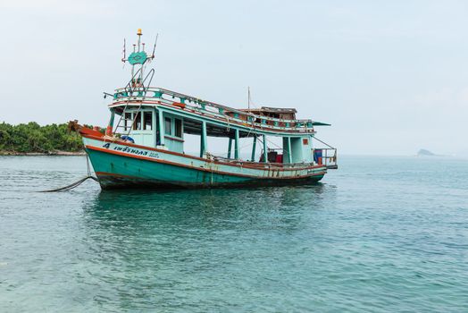 old small fishing boat on blue sea, taken on a sunny day