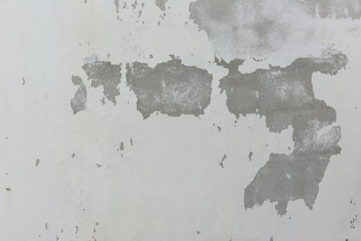 Cracks on solid white painted concrete wall, large and small crack, symbolized danger and destructions