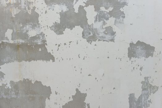 Cracks on solid white painted concrete wall, large and small crack, symbolized danger and destructions