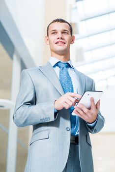 businessman running in the Tablet PC in the office