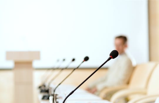 close-up microphone, on the background of business communication at the conference