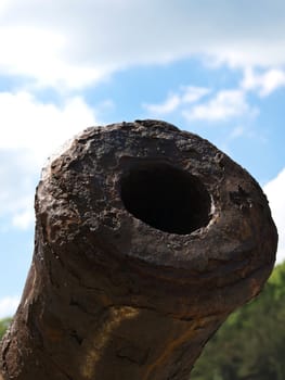 old rusty canon on the blue sky