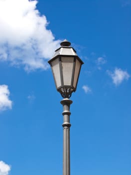 old iron street lamp on the blue sky