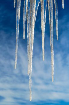 Frozen Icicles Isolated over Blue Sky with clouds