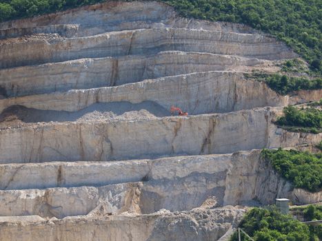 bigh high quarries with bulldozer on the top