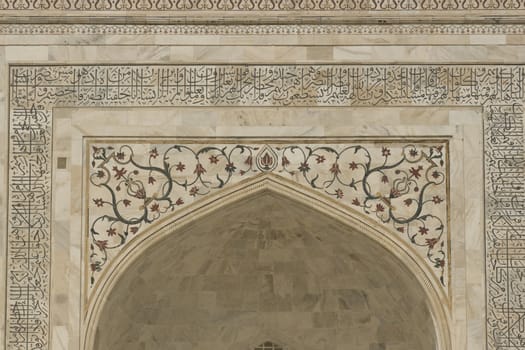 Detail of white mable arch inlaid with semi-precious stones. Taj Mahal, Agra, Uttar Pradesh, India