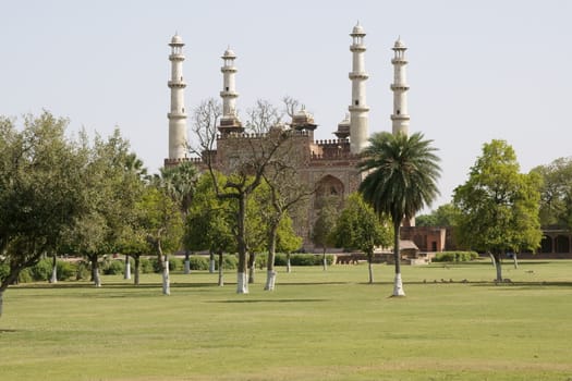 Akbar's tomb on the outskirts of Agra in India. Islamic style building with minarets set in formal gardens.