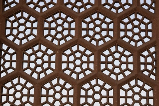 Detail of islamic window screen carved out of red sandstone at Akbar's tomb on the outskirts of Agra in India.
