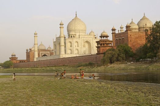 Indian family washing in the River Yamuna near the Taj Mahal. Agra, Uttar Pradesh, India