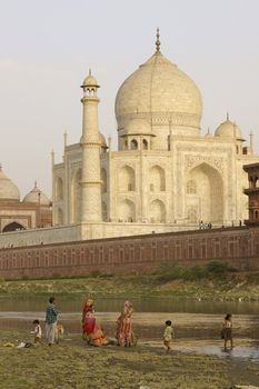 Indian family washing in the River Yamuna near the Taj Mahal. Agra, Uttar Pradesh, India