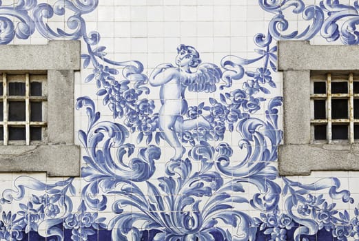 Portuguese facade with windows, detail of a facade decorated with angels tile