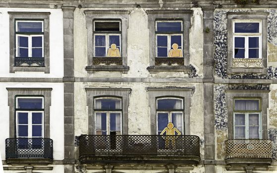 Windows with silhouettes, detail of a facade in the city of Porto, Portugal