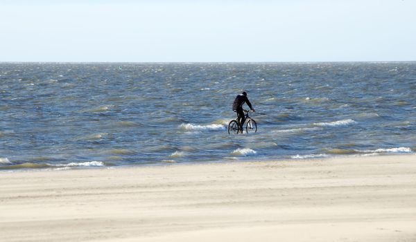 man with bike in the sea