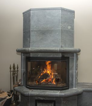 fire place in home with flames and wood