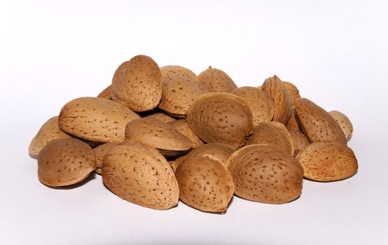 Almonds in shells isolated on white background.
