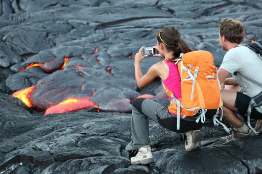 Hawaii lava tourist. Tourists taking photo of flowing lava from Kilauea volcano around Hawaii volcanoes national park, USA.