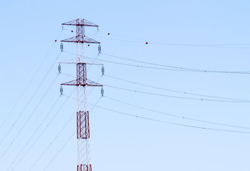 Detail of electricity pylon against blue sky