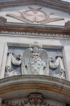 An old coat of arms on an old building in Pisa
