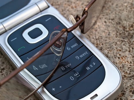 cellular phone and eye glasses