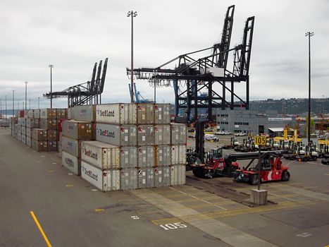 A photograph of a shipping terminal where cargo is loaded and unloaded from ships.