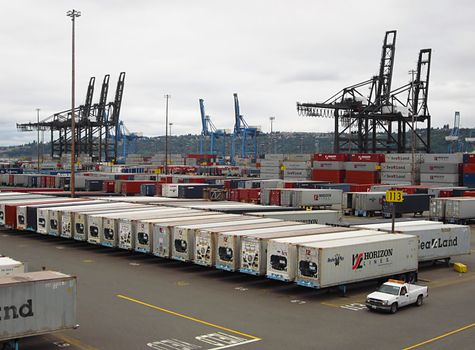 A photograph of a shipping terminal where cargo is loaded and unloaded from ships.