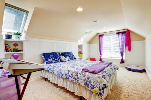 Girl bedroom with attic  vaulted ceiling and beige carpet with toys.