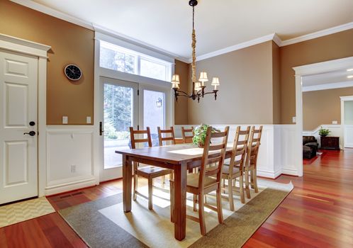 Large bright beige dining room with cherry hardwood.