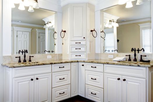 Luxury large white master bathroom cabinets with double sinks.