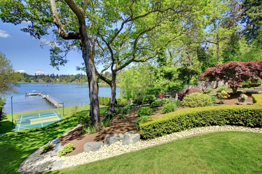 Luxury real estate lake view from home balcony with beautiful yard landscape.