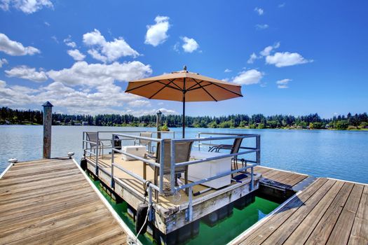 Lake with wood pier and private party raft.