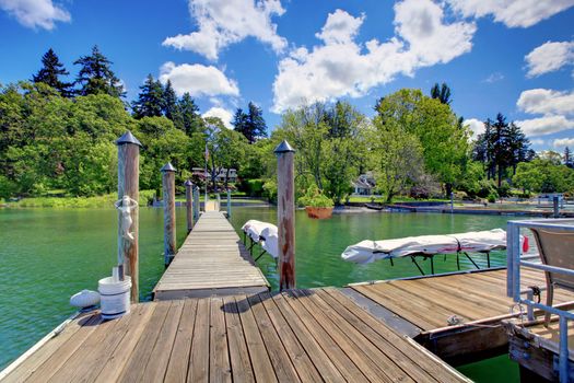 Lake with long wood pier and private party raft.