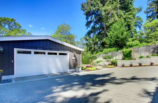 Garage door and large front parking area.