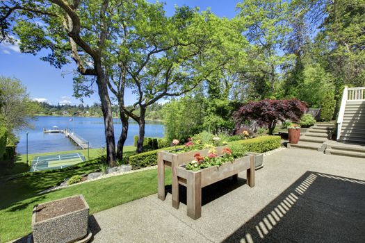 Luxury real estate lake view from home balcony with beautiful yard landscape.